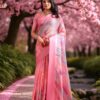 Model in soft coral Kota cotton saree with subtle checked base and printed details.